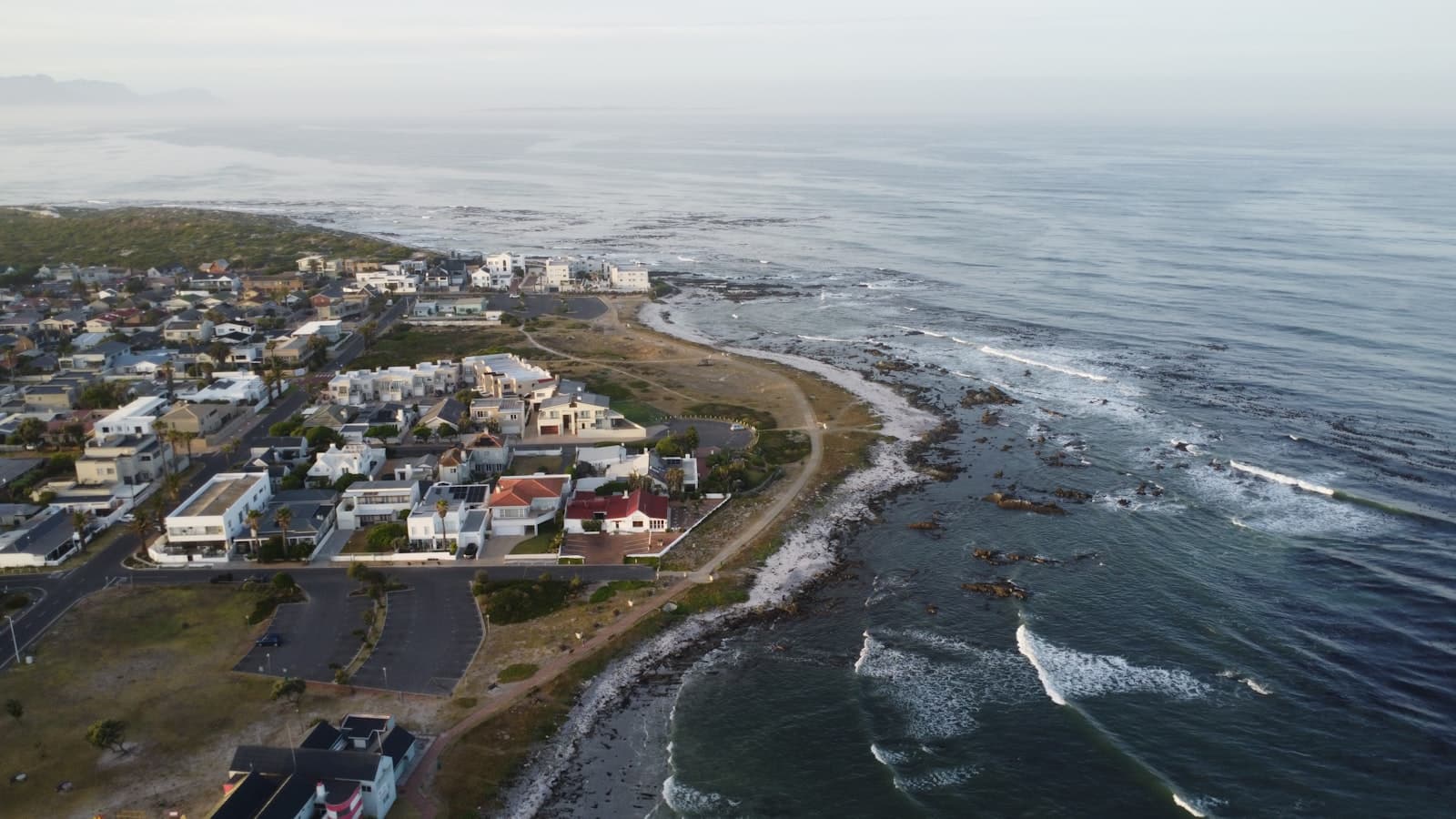 An aerial view of a coastal town at dawn